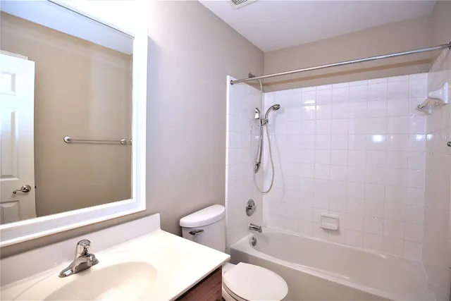 a bathroom with a sink toilet tub and shower