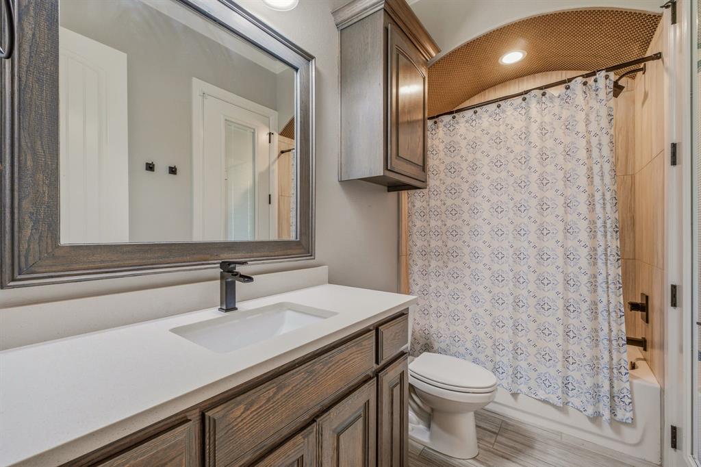 9503 Bellechase Road Granbury, TX 76049 - Photo 27 of 40 a bathroom with a sink a toilet and shower