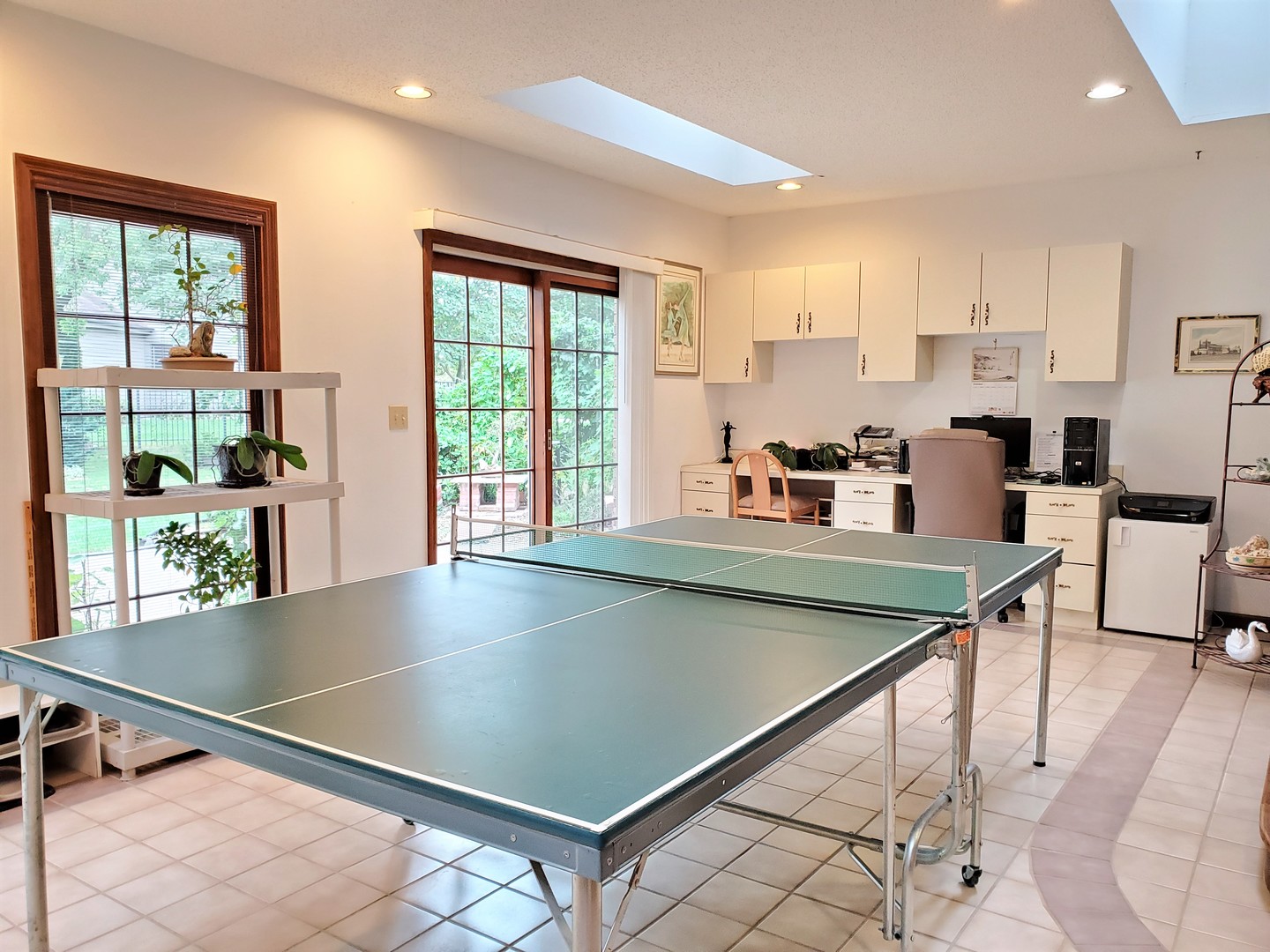 1013 Galen Drive Champaign, IL 61821 - Photo 24 of 68 a kitchen with stainless steel appliances granite countertop a stove top oven a sink dishwasher a dining table and chairs with wooden floor