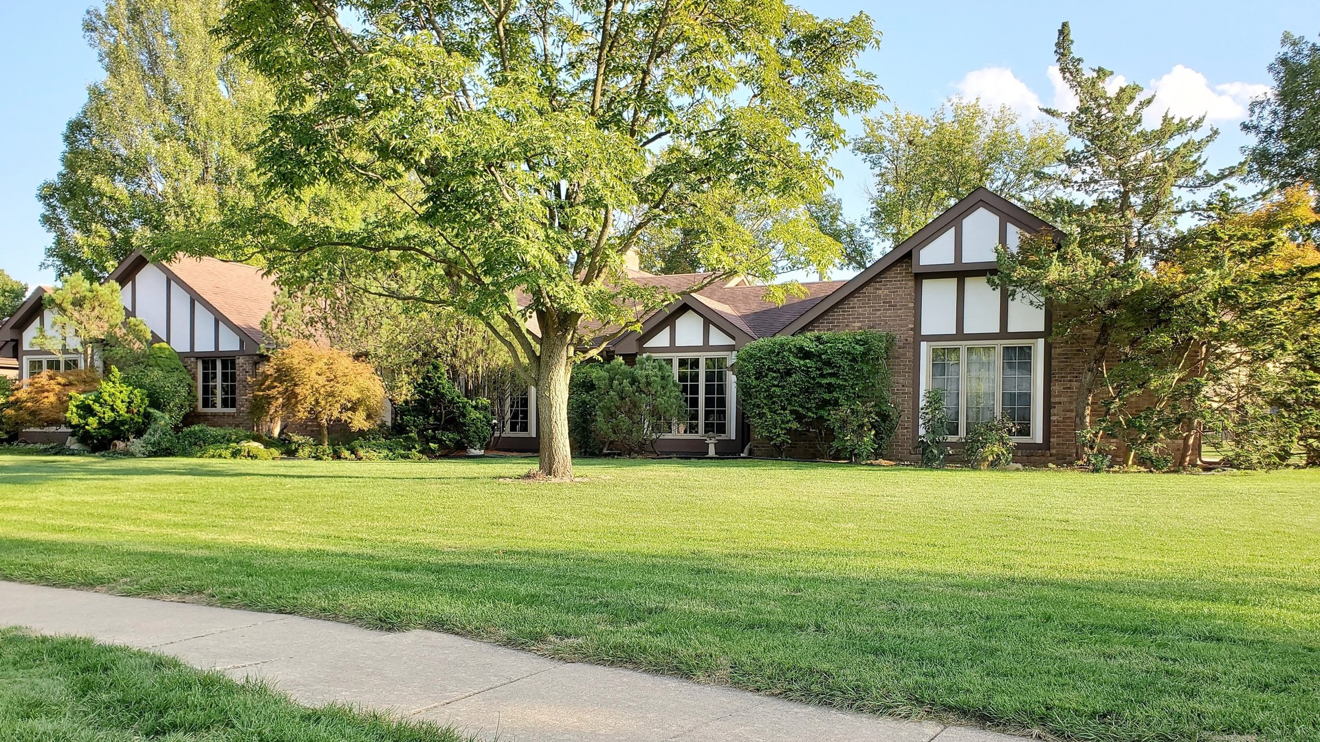 1013 Galen Drive Champaign, IL 61821 - Photo 6 of 68 a front view of a house with a yard and trees