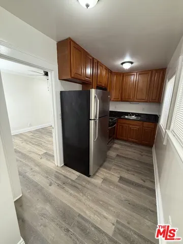 a kitchen with granite countertop wooden cabinets and stainless steel appliances