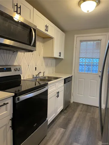 a kitchen with a stove microwave and sink