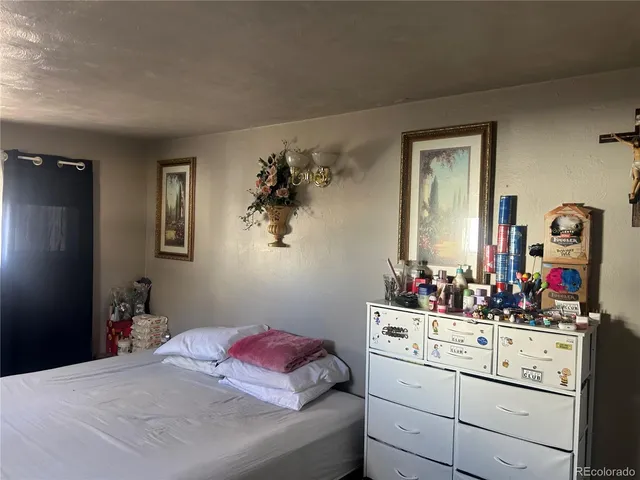 a bedroom with a bed and a dresser