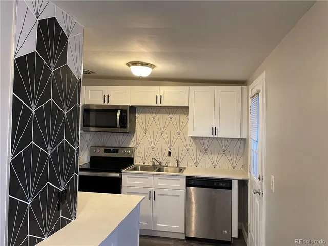 a kitchen with stainless steel appliances a stove and a refrigerator