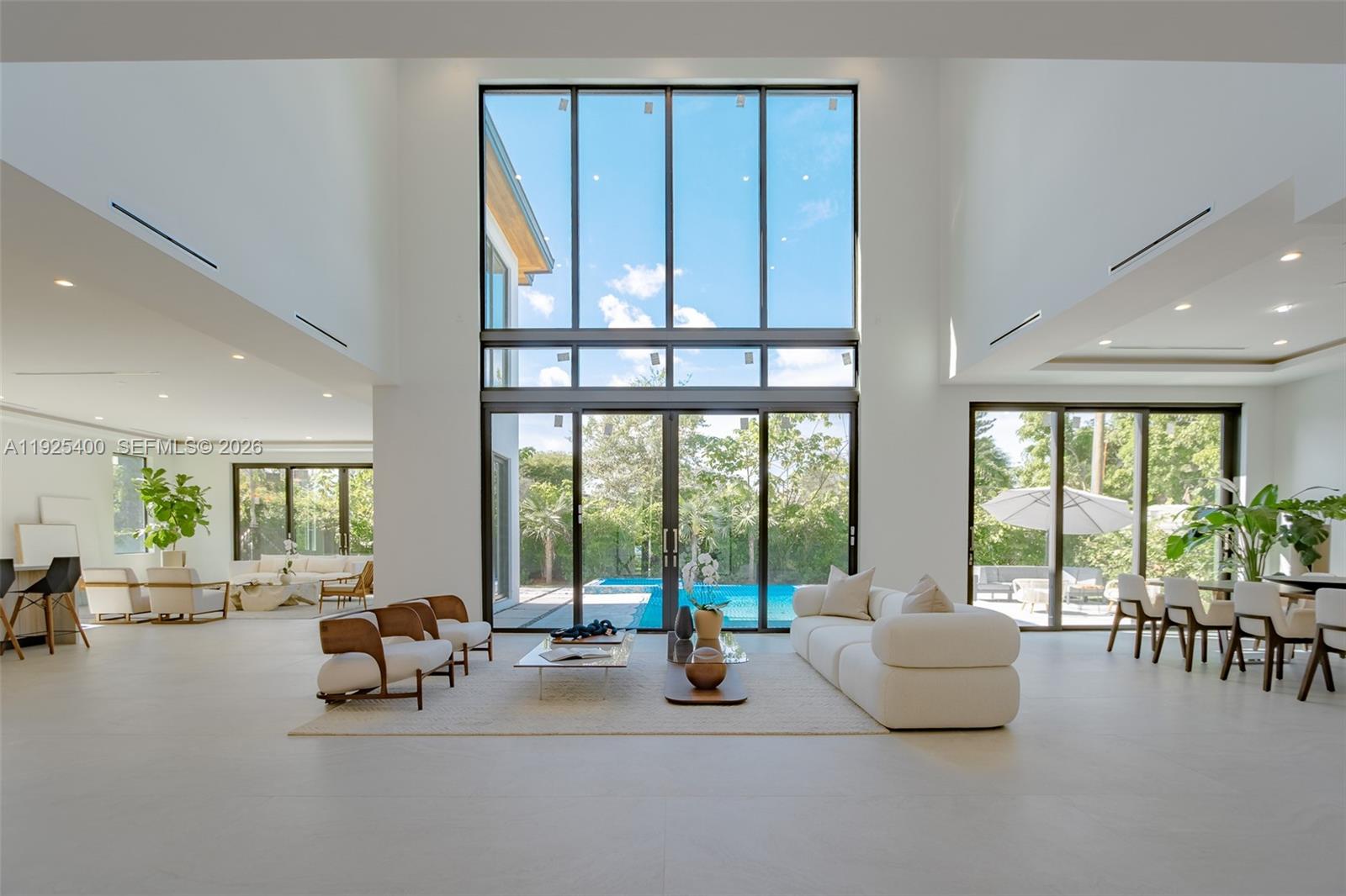 9840 Southwest 73rd Court Pinecrest, FL 33156 - Photo 9 of 67 Modern living area with large glass slinding doors that offers a Panoramic view and access to an exterior area.