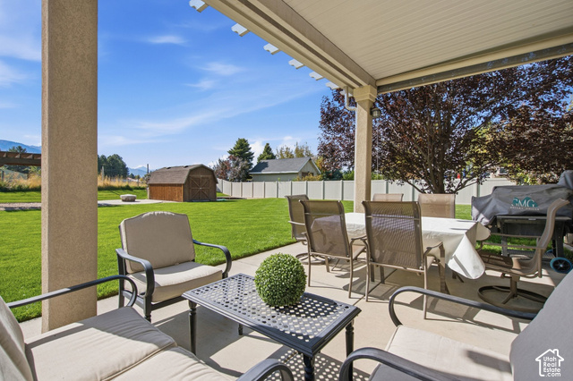 1447 Meadow Lane Mapleton, UT 84664 - Photo 38 of 67 Covered concrete patio with a solid roof and a decorative pergola extension