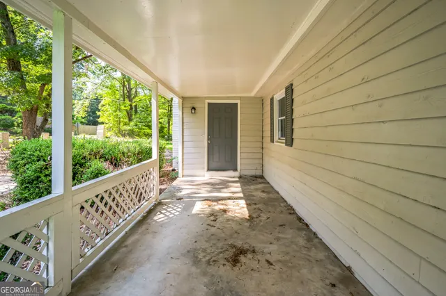 a view of a porch with wooden floor and roof