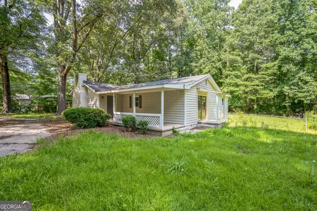 a backyard of a house with plants and trees