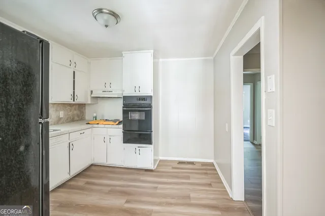 a view of a kitchen with wooden floor