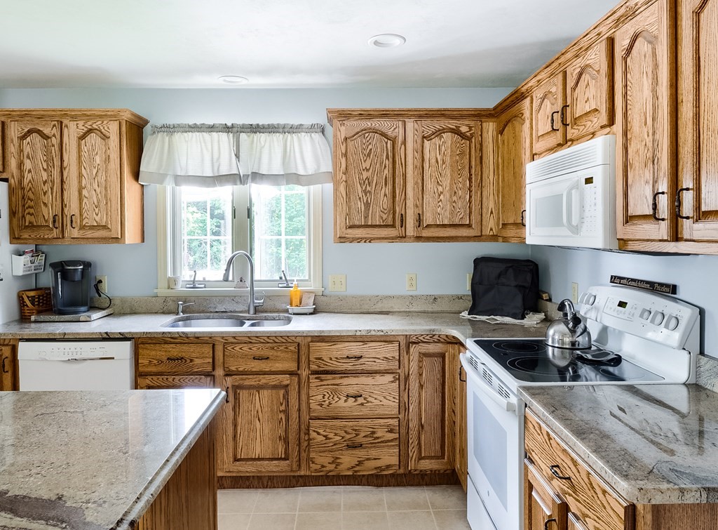 8 10 Rod Road Rutland, MA 01543 - Photo 6 of 32 a kitchen with stainless steel appliances granite countertop a stove a sink and a microwave
