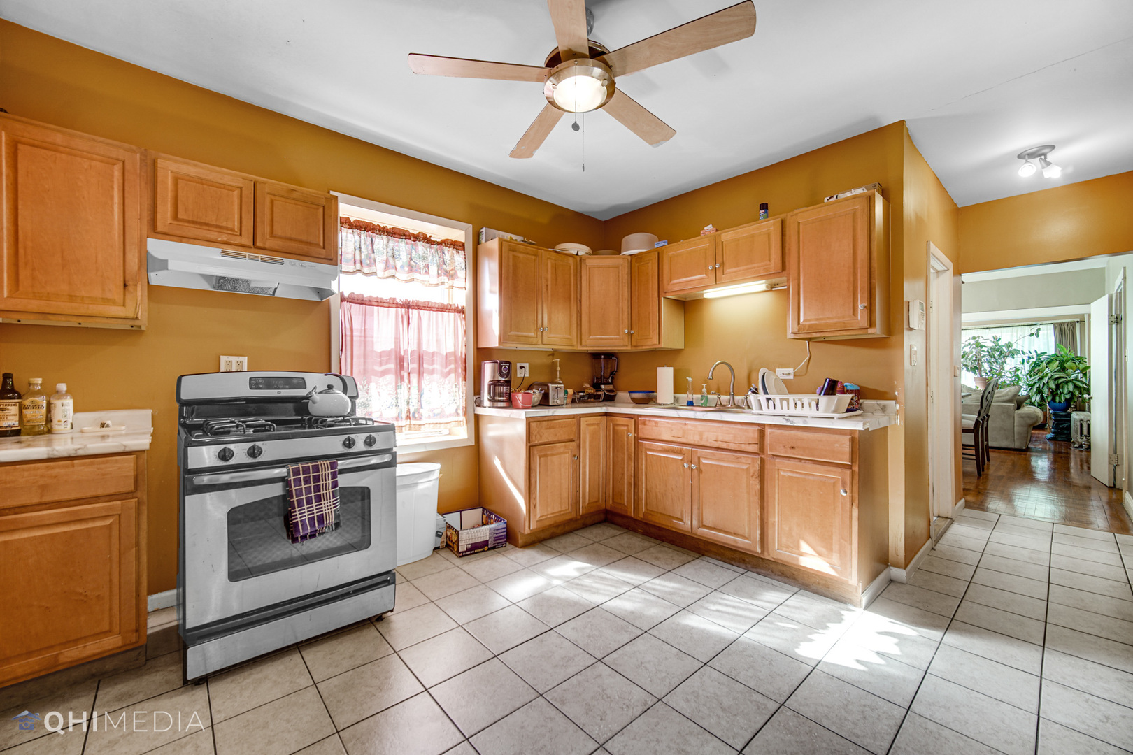 8417 South Manistee Avenue Chicago, IL 60617 - Photo 12 of 25 a kitchen with a stove a sink and a refrigerator