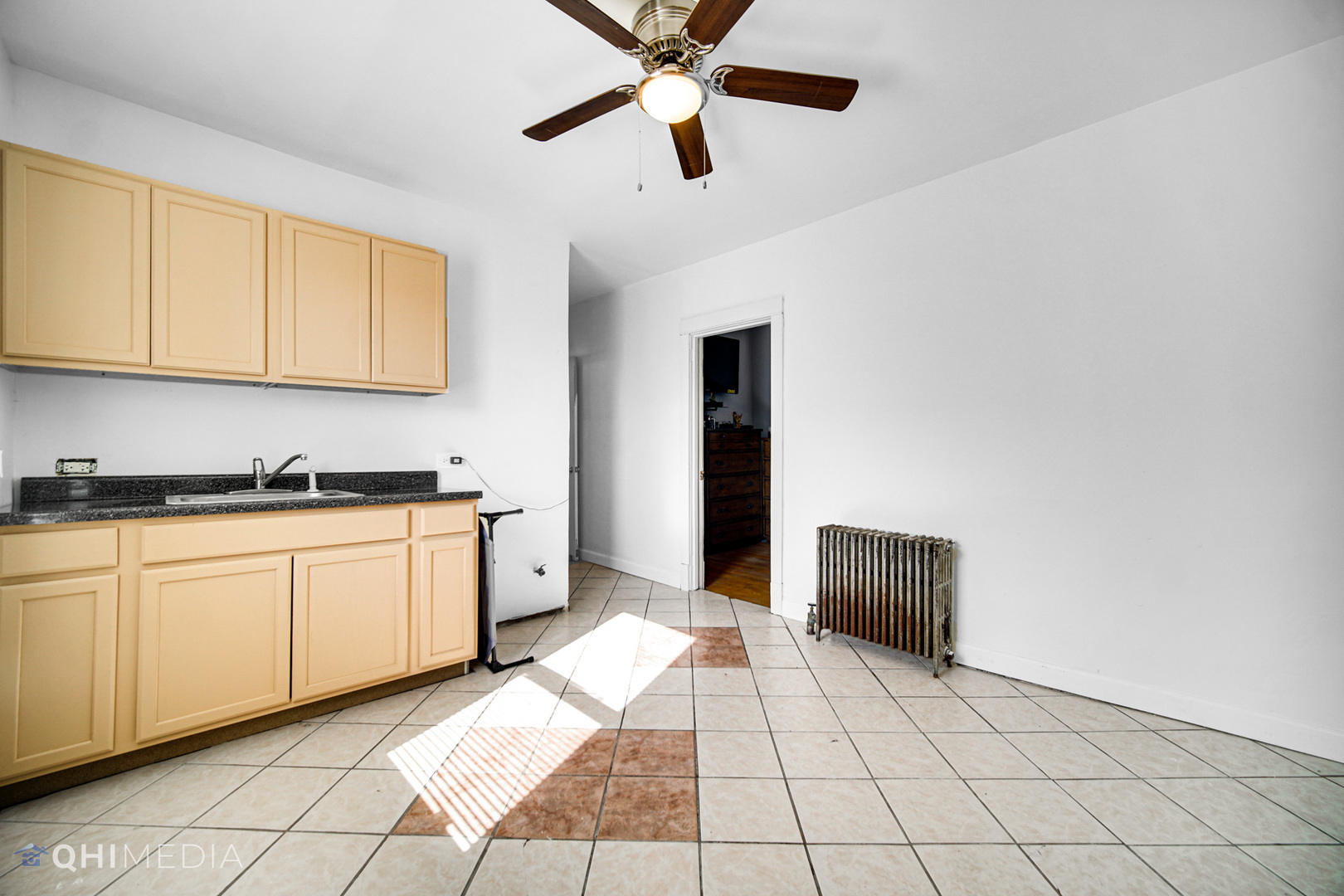 8417 South Manistee Avenue Chicago, IL 60617 - Photo 13 of 25 a spacious bedroom with a bed and a chandelier
