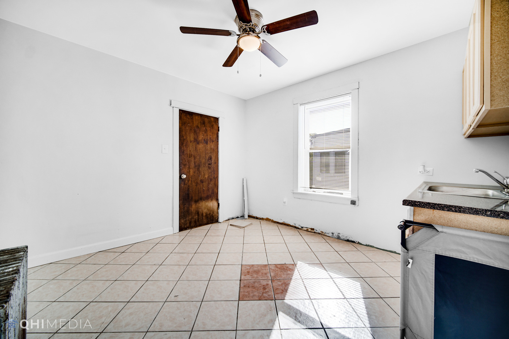 8417 South Manistee Avenue Chicago, IL 60617 - Photo 14 of 25 a view of a livingroom with a chandelier fan and a window