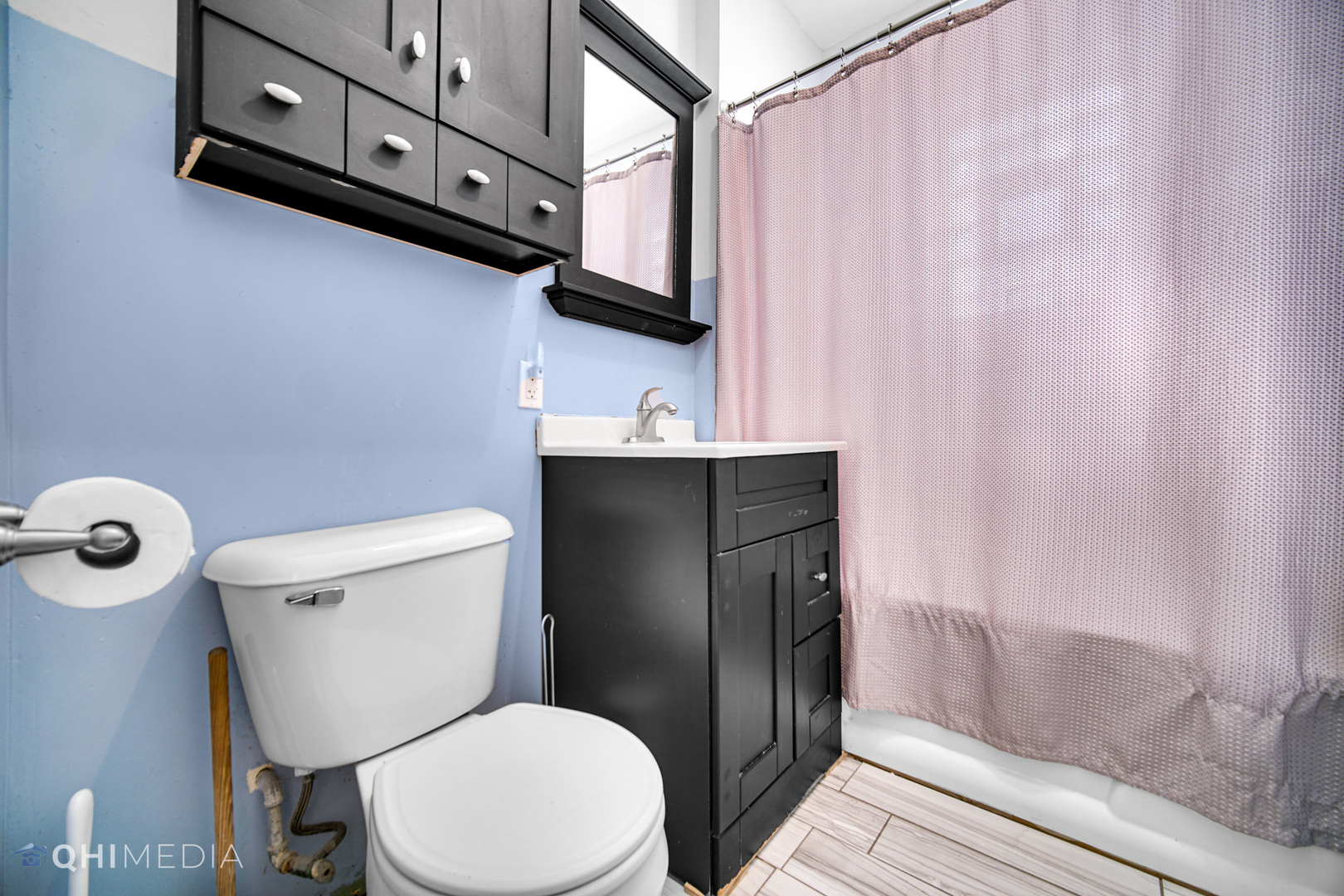 8417 South Manistee Avenue Chicago, IL 60617 - Photo 20 of 25 a white toilet sitting next to a bathroom sink