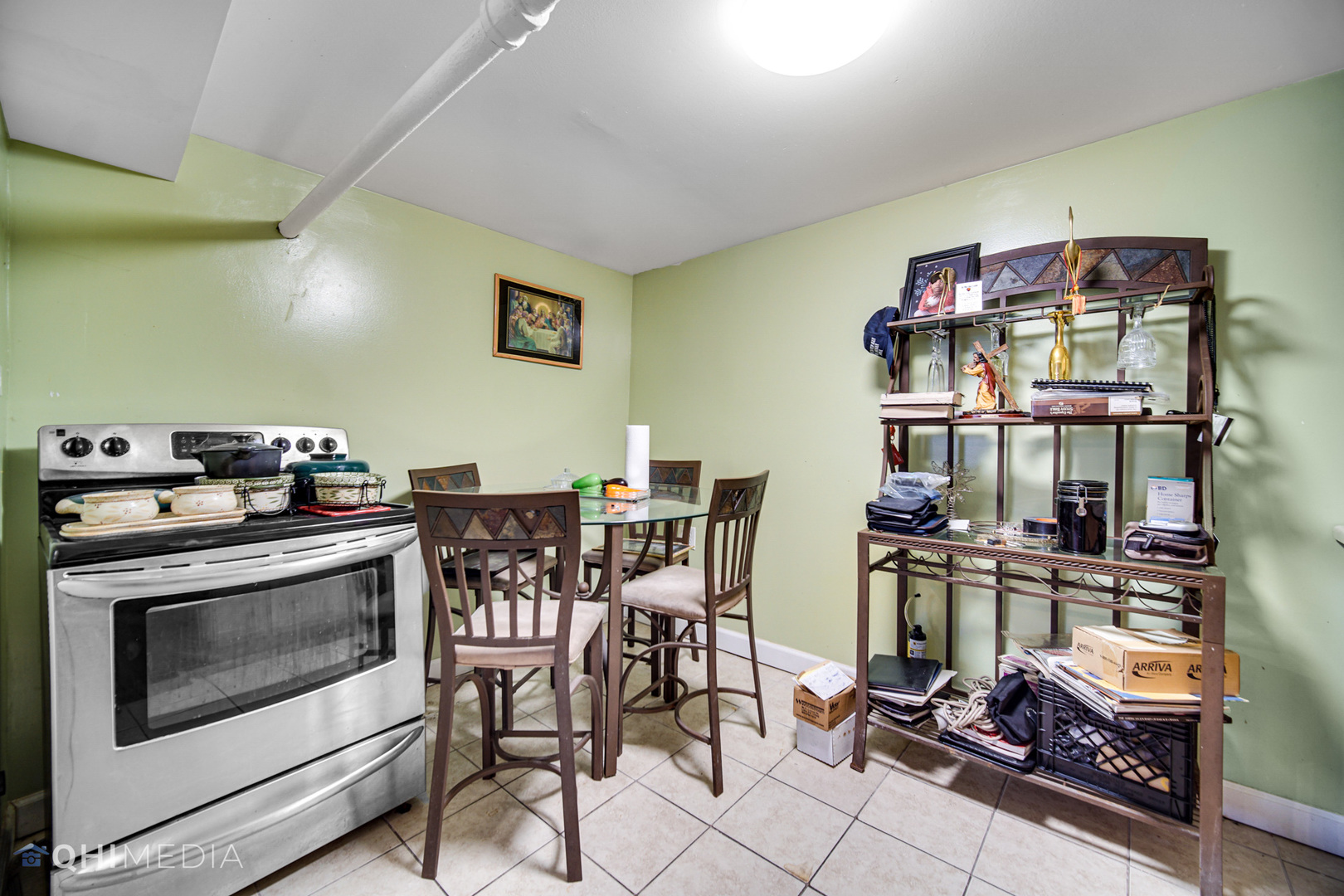 8417 South Manistee Avenue Chicago, IL 60617 - Photo 23 of 25 a kitchen with stainless steel appliances a stove a table and chairs in it