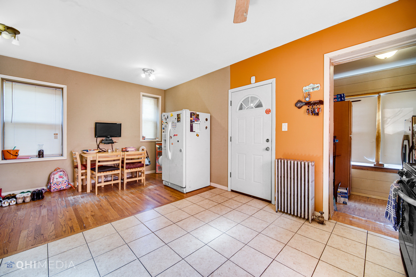 8417 South Manistee Avenue Chicago, IL 60617 - Photo 10 of 25 a living room with furniture a flat screen tv and next to a window