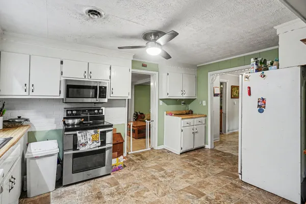 a kitchen with stainless steel appliances a refrigerator stove microwave and sink