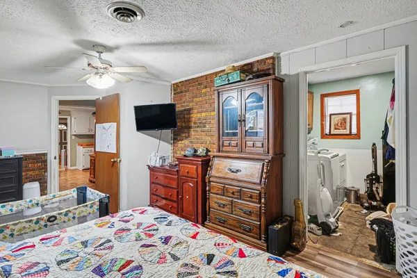 a bedroom with a bed and flat screen tv