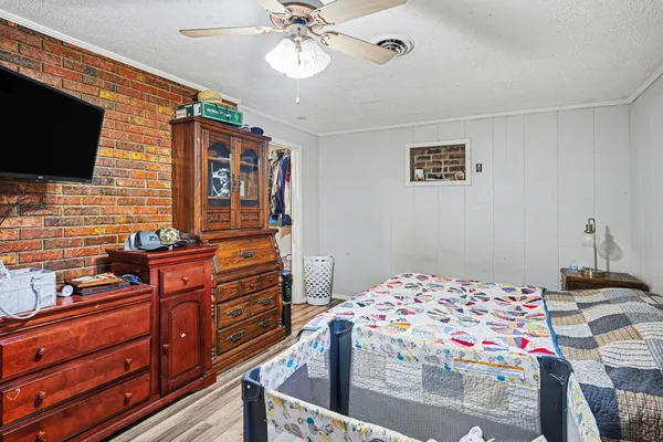 a bedroom with a bed and flat screen tv