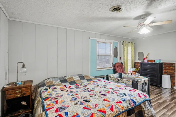 a bedroom with a bed and a chandelier