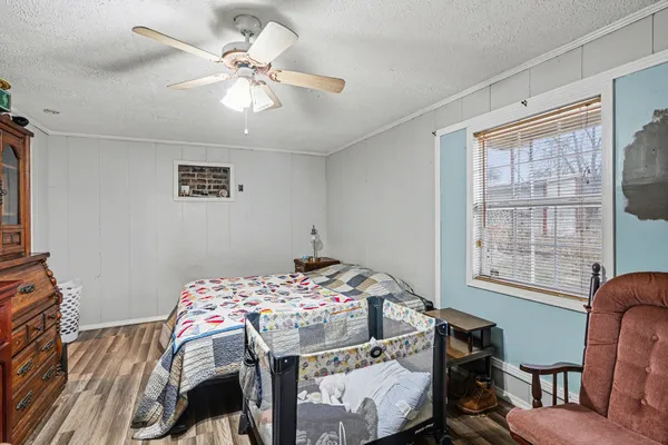 a bedroom with a bed and a chair