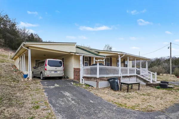 a view of a house with a yard and sitting area