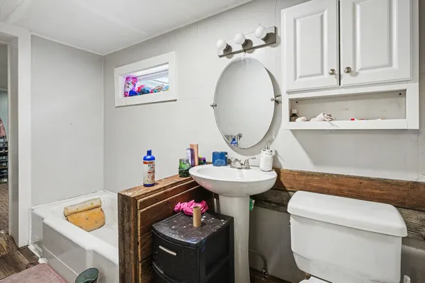 a bathroom with a sink a toilet and a mirror