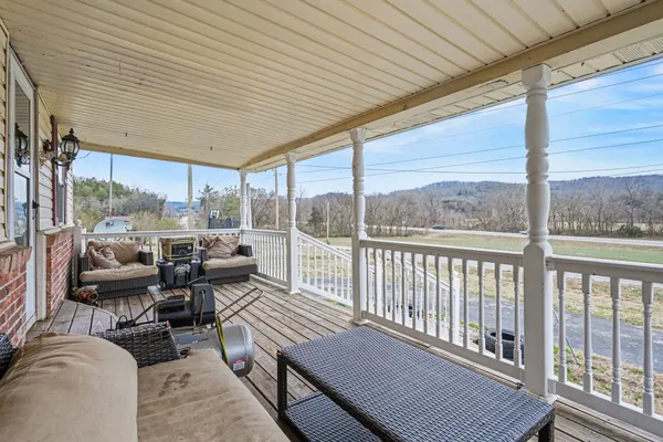 a balcony with furniture and a potted plant