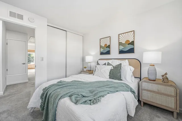 a bedroom with a bed and a couch