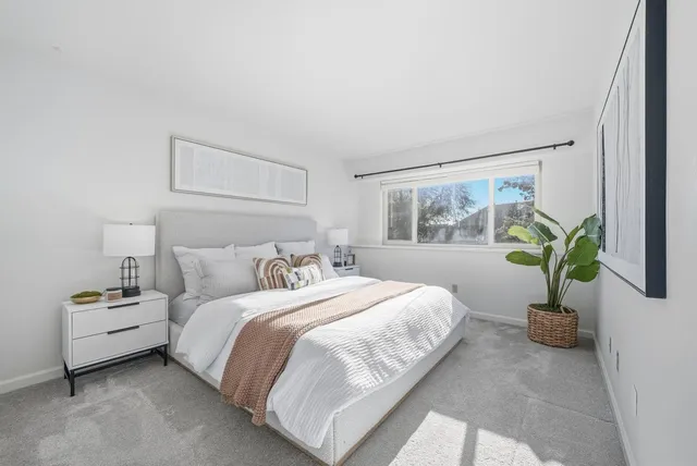 a bedroom with bed and a window