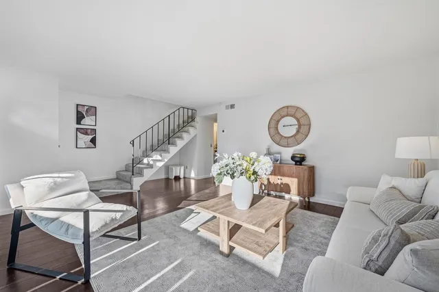 a living room with furniture and a clock