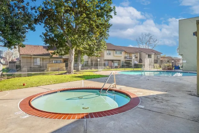 a view of a house with swimming pool and sitting area