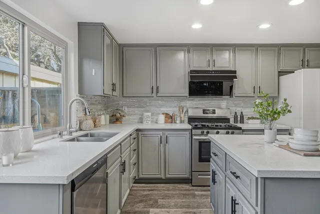 a kitchen with a sink stove and refrigerator