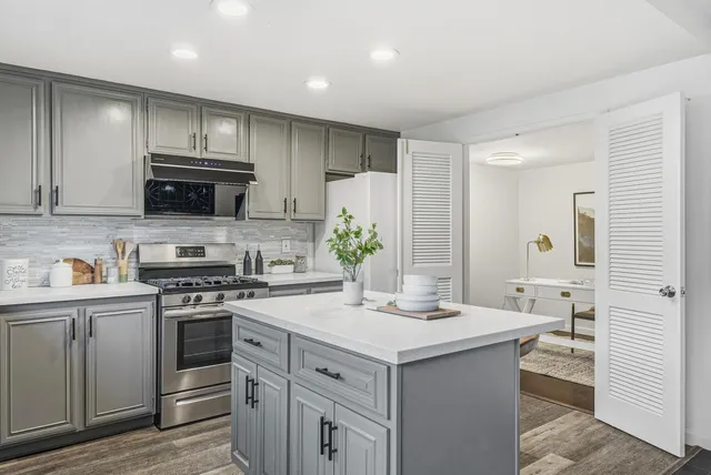 a kitchen with a sink stove and cabinets