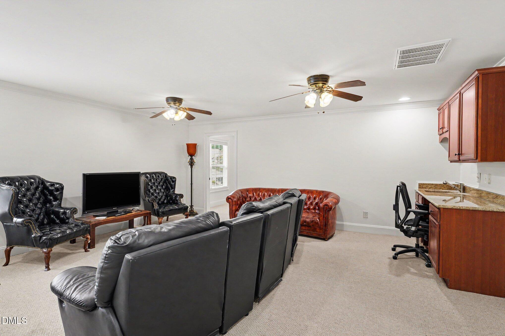 1729 Frenchwood Drive Raleigh, NC 27612 - Photo 26 of 46 a living room with furniture and a flat screen tv