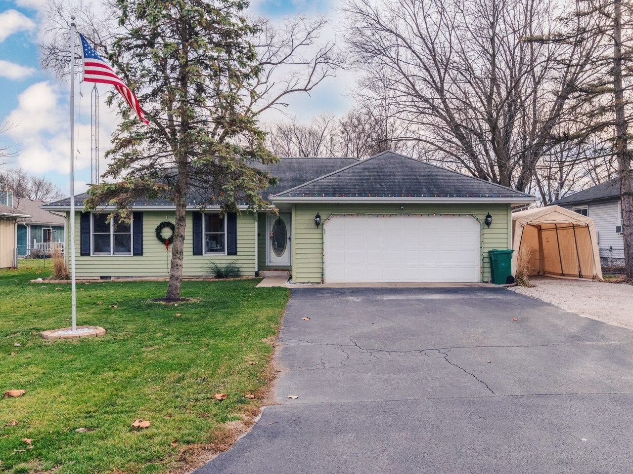 319 West Cermak Road Braidwood, IL 60408 - Photo 1 of 32 a house that has a tree in front of it