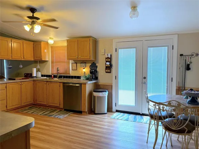 a kitchen with a table chairs sink and cabinets