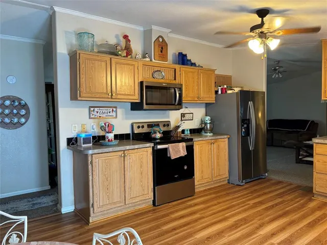 a kitchen with stainless steel appliances granite countertop a refrigerator a stove top oven a sink and dishwasher