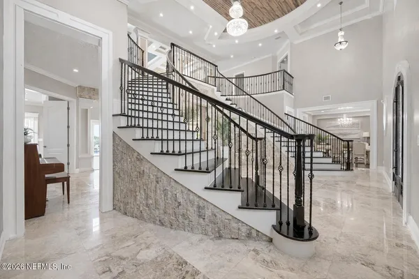 a kitchen with stainless steel appliances kitchen island granite countertop a table chairs sink and cabinets