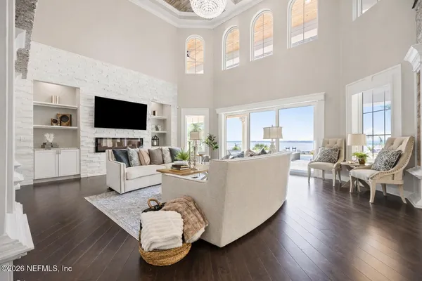 a large white kitchen with stainless steel appliances granite countertop a sink and cabinets
