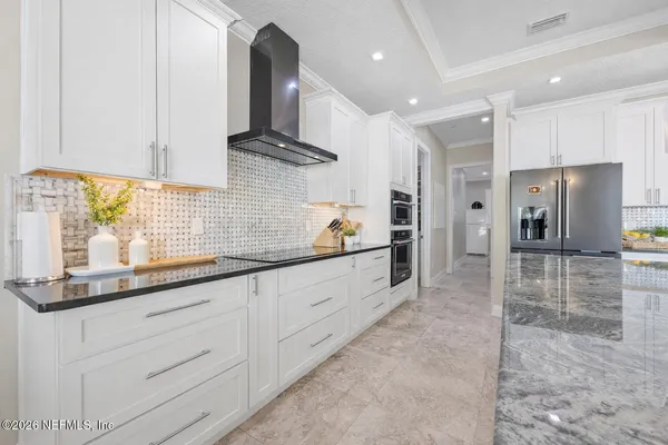 a bathroom with a granite countertop sink a toilet and a mirror