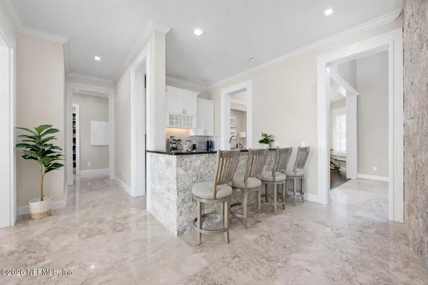 a bathroom with a granite countertop sink two mirror and a bathtub
