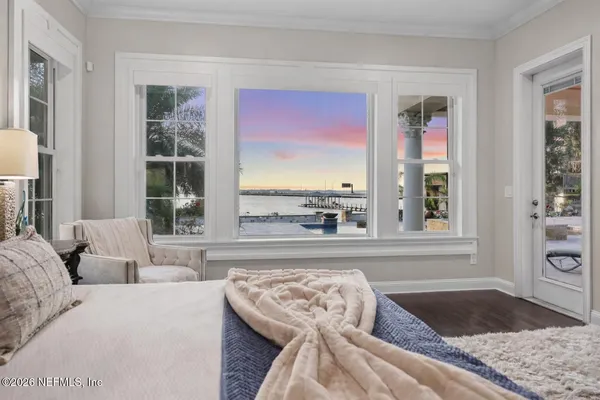 a spacious bedroom with a bed and a flat screen tv