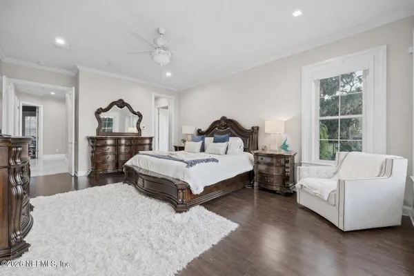 a bedroom with a large bed and a chandelier