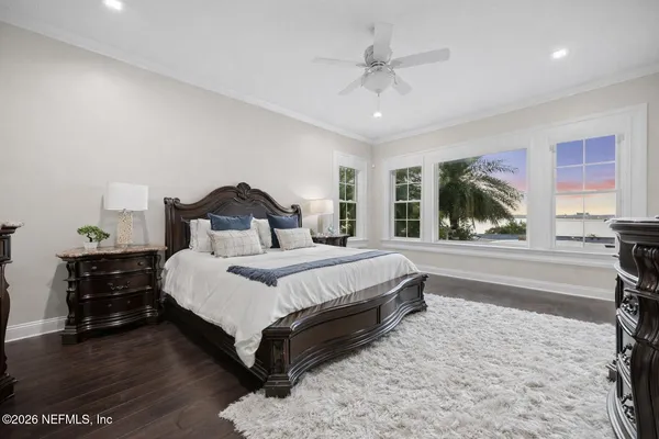 a patio with a table and chairs and potted plants