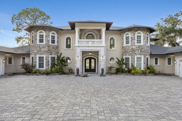 a large white kitchen with stainless steel appliances granite countertop a sink and cabinets