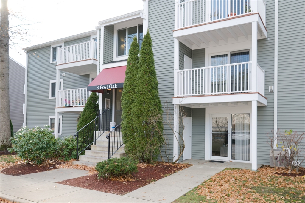 3 Post Oak Lane, Unit 9 Natick, MA 01760 - Photo 1 of 30 a front view of a house with a garden