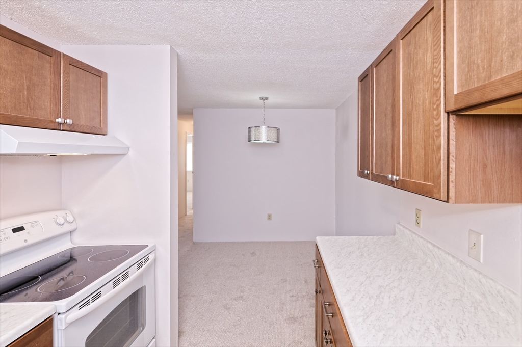 3 Post Oak Lane, Unit 9 Natick, MA 01760 - Photo 11 of 30 a kitchen with a sink and cabinets