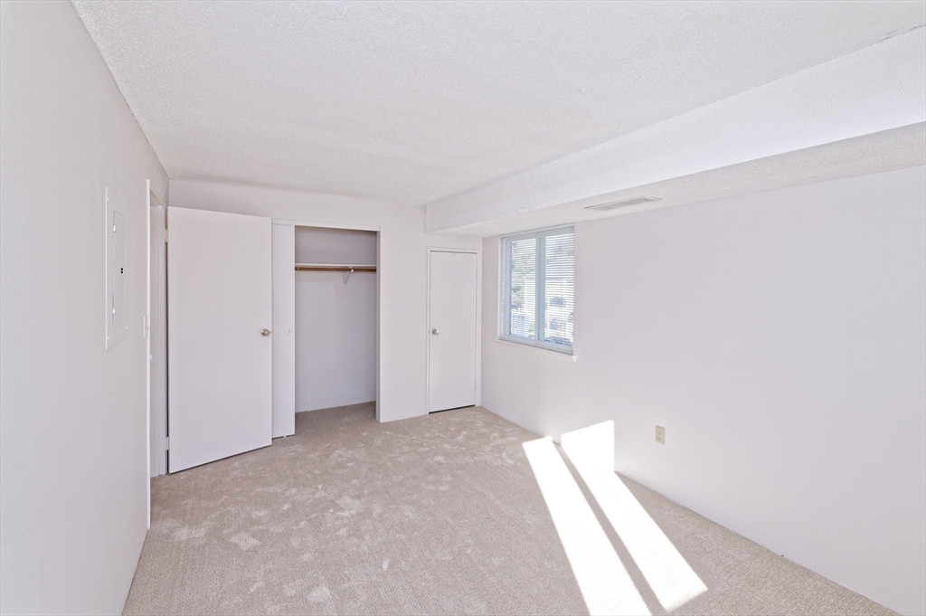 3 Post Oak Lane, Unit 9 Natick, MA 01760 - Photo 17 of 30 a view of an empty room with a window