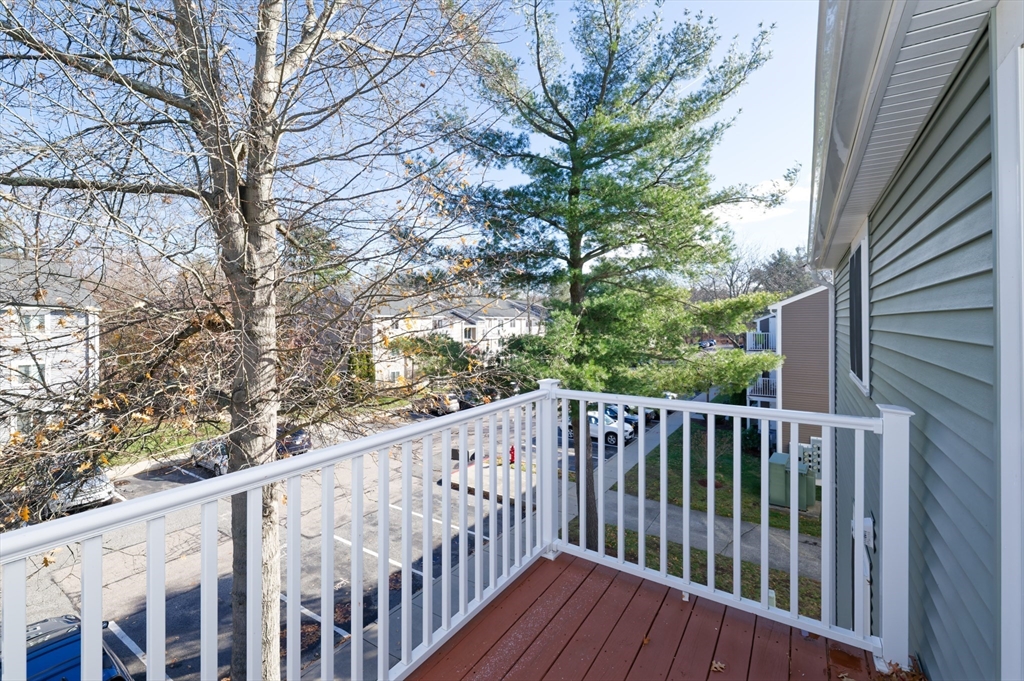 3 Post Oak Lane, Unit 9 Natick, MA 01760 - Photo 24 of 30 a view of balcony with wooden fence and floor
